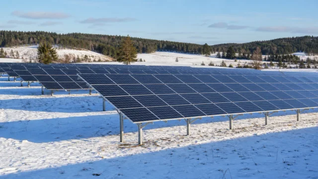 Solar farm with conventional and vertical bifacial modules in a snowy Northern European setting